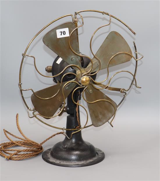 A 1920/30s fan with brass blades and ornate front height 40cm
